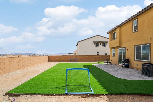 view of yard featuring a patio area, a fenced backyard, and central air condition unit