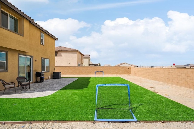 view of yard featuring a patio area, a fenced backyard, and central AC unit