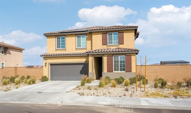 mediterranean / spanish-style house with concrete driveway, an attached garage, fence, and stucco siding