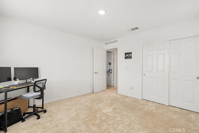 carpeted office space with baseboards and visible vents