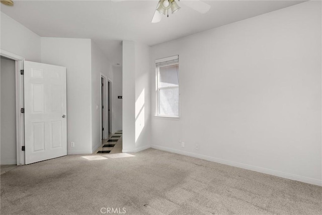 unfurnished bedroom with carpet flooring, baseboards, and ceiling fan