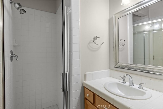 full bathroom featuring a shower stall and vanity