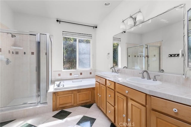 full bathroom featuring a shower stall, double vanity, and a sink