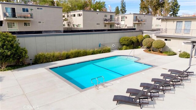 pool featuring a residential view and a patio