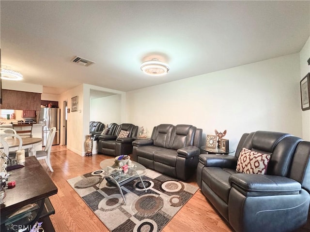 living area featuring visible vents and light wood-type flooring