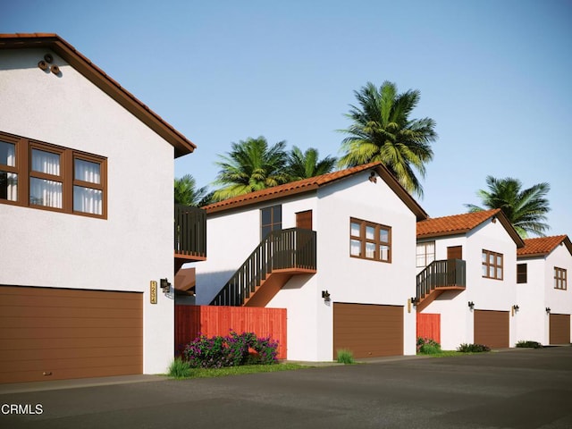 view of front facade with a balcony and stucco siding