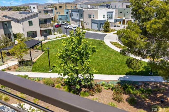 view of community featuring a yard and a residential view