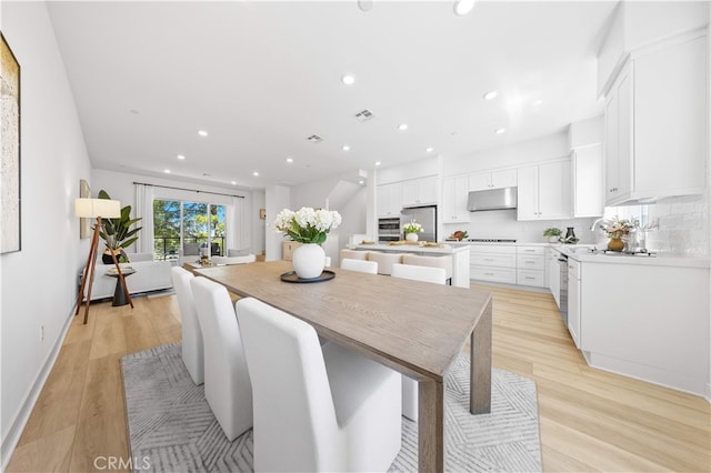 dining space featuring baseboards, light wood finished floors, recessed lighting, and visible vents