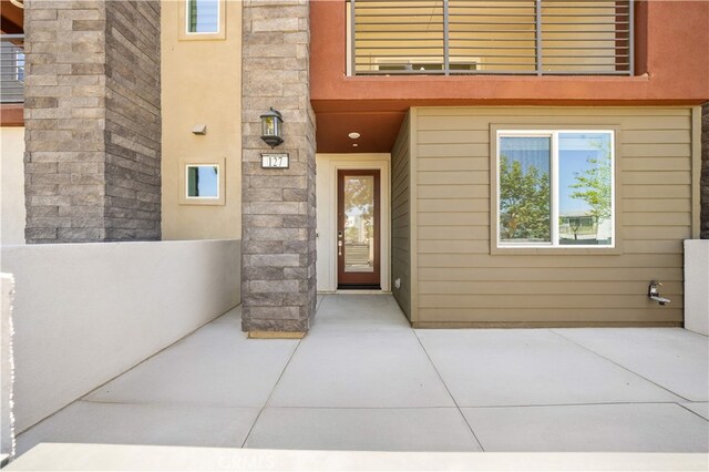 property entrance with stone siding