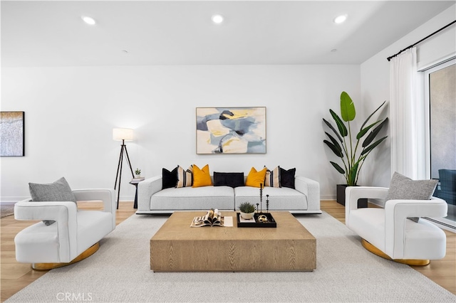 living area featuring recessed lighting, baseboards, and wood finished floors