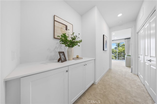 hall featuring light colored carpet, baseboards, and recessed lighting