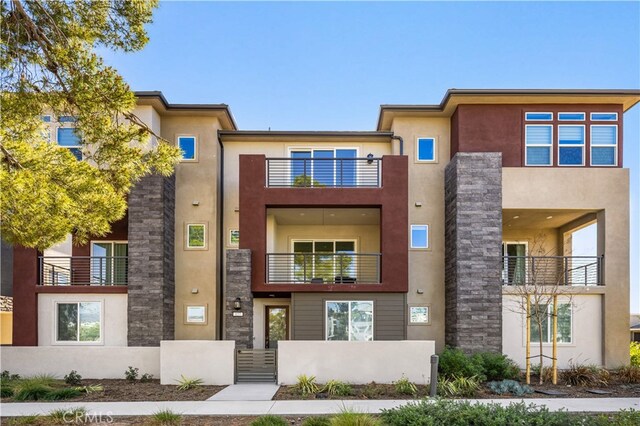 exterior space featuring a balcony and stucco siding