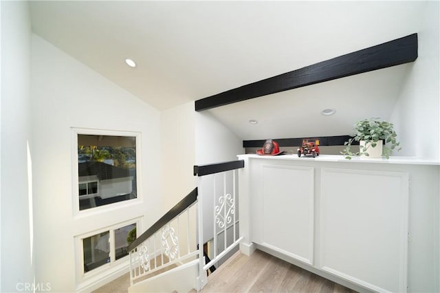 interior space featuring vaulted ceiling, light wood-type flooring, an upstairs landing, and recessed lighting