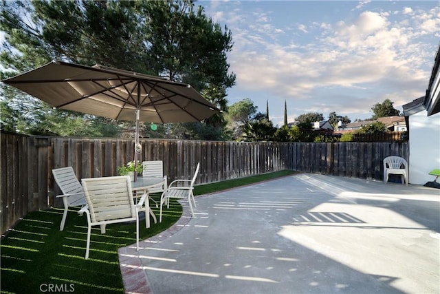 exterior space featuring outdoor dining area and a fenced backyard