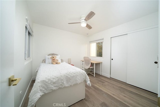 bedroom featuring a closet, ceiling fan, and wood finished floors