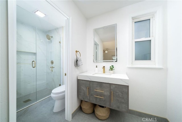 bathroom with tile patterned flooring, toilet, vanity, and a marble finish shower