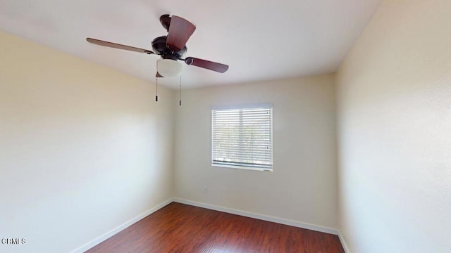 empty room with baseboards, ceiling fan, and wood finished floors