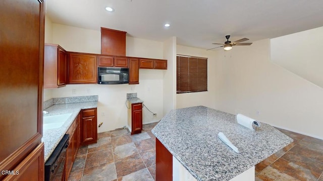 kitchen with stone finish flooring, a sink, a center island, black appliances, and ceiling fan