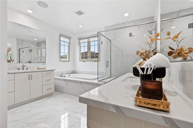 full bathroom featuring visible vents, a garden tub, two vanities, marble finish floor, and a marble finish shower