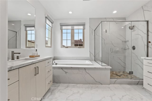 bathroom featuring a marble finish shower, plenty of natural light, and vanity