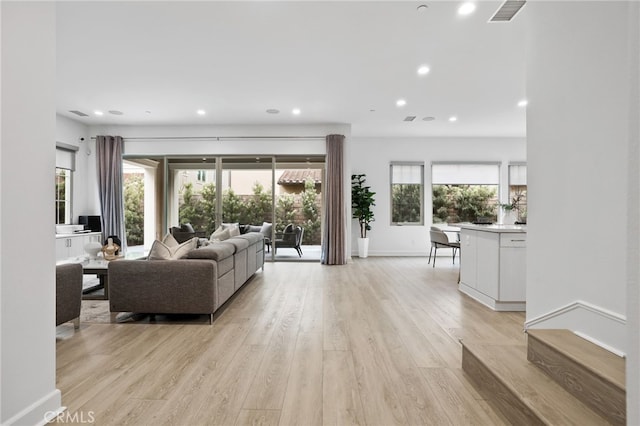 living room with visible vents, recessed lighting, baseboards, and light wood-style floors