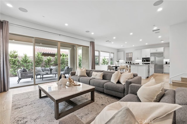 living room with recessed lighting and light wood-type flooring