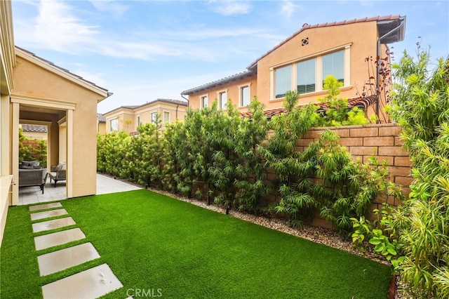 view of yard featuring fence and a patio area