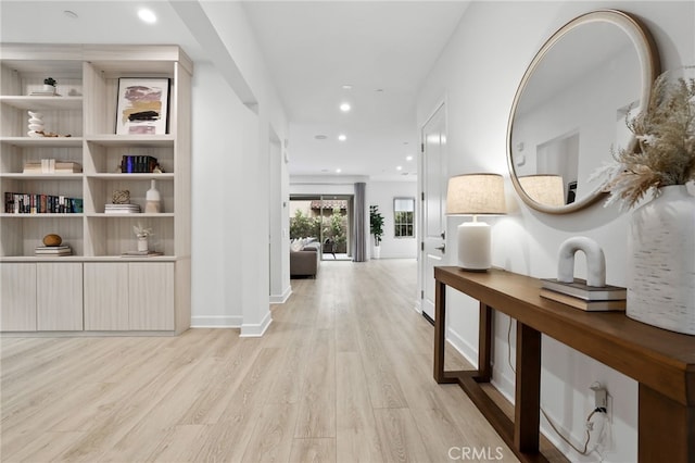 hall with recessed lighting, baseboards, and light wood-style floors