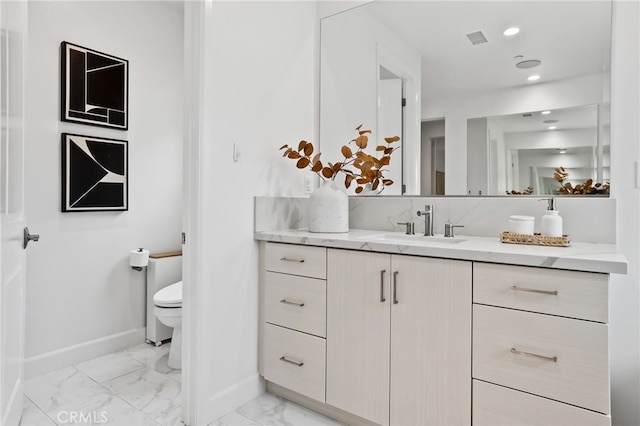 bathroom featuring vanity, visible vents, baseboards, toilet, and marble finish floor