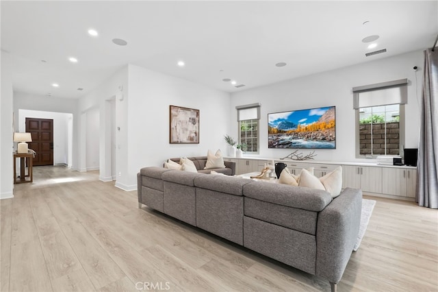 living room with visible vents, recessed lighting, and light wood-type flooring