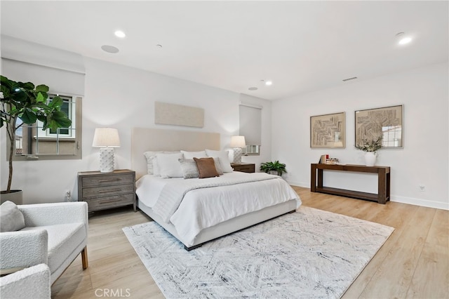 bedroom featuring recessed lighting, light wood-type flooring, and baseboards