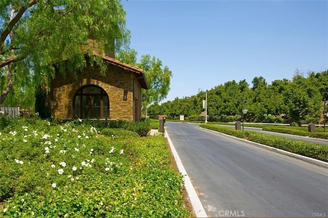 view of road with curbs and street lighting