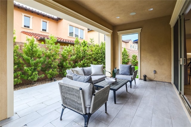 view of patio featuring an outdoor living space and fence