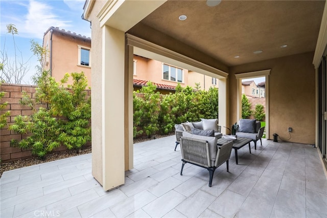 view of patio with an outdoor hangout area and fence