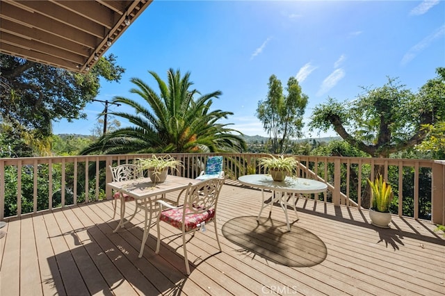 wooden terrace with outdoor dining area