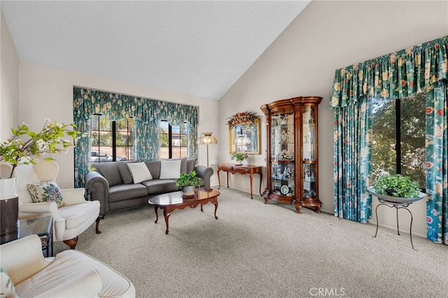 carpeted living room featuring high vaulted ceiling