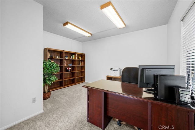 office area with carpet flooring and a textured ceiling