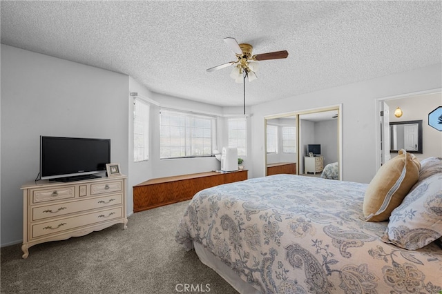 carpeted bedroom featuring a ceiling fan, a closet, and a textured ceiling