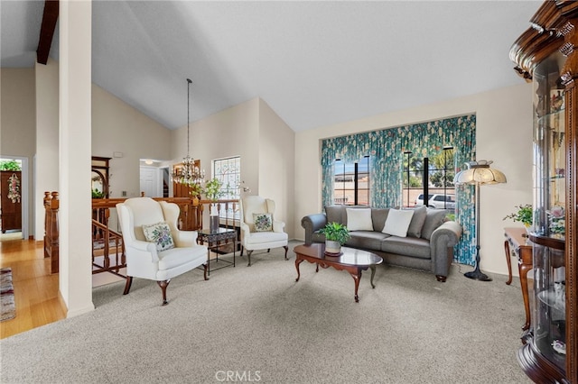 carpeted living area with beam ceiling, high vaulted ceiling, and an inviting chandelier