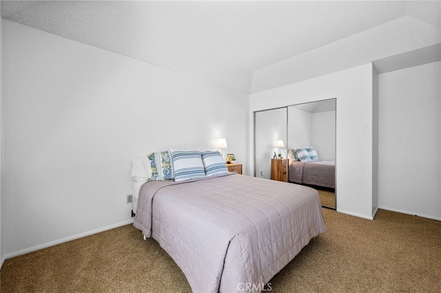 carpeted bedroom featuring a closet and baseboards