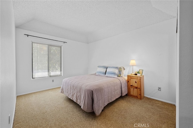 carpeted bedroom with vaulted ceiling, baseboards, and a textured ceiling