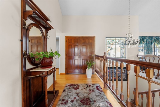 entryway with a chandelier and light wood-type flooring