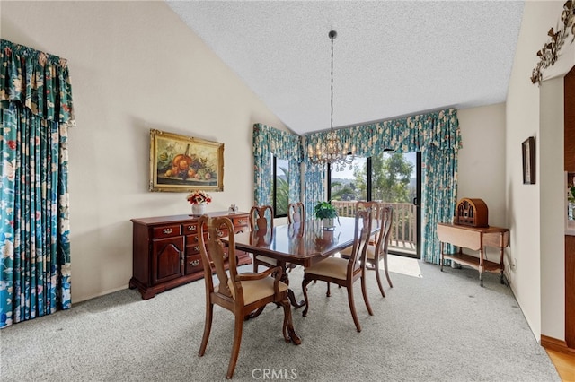 dining room featuring a notable chandelier, light colored carpet, a textured ceiling, and vaulted ceiling