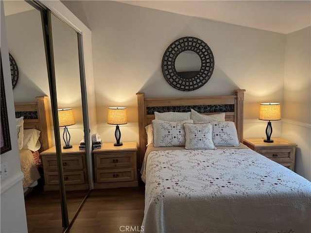 bedroom with dark wood finished floors