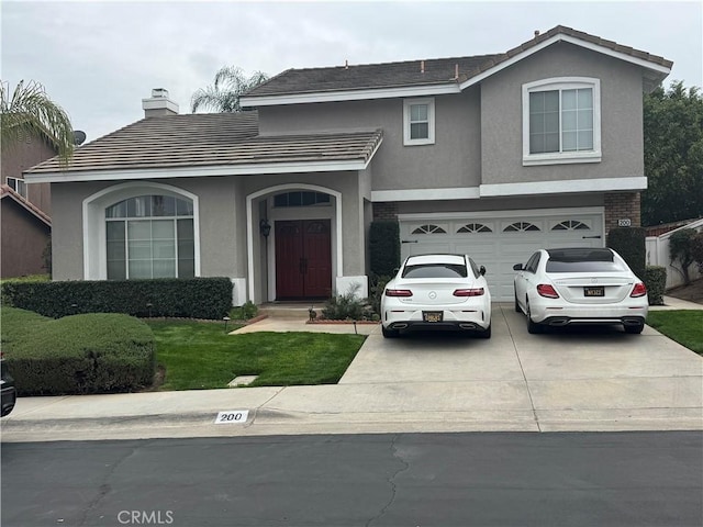 traditional home with an attached garage, a chimney, concrete driveway, and stucco siding