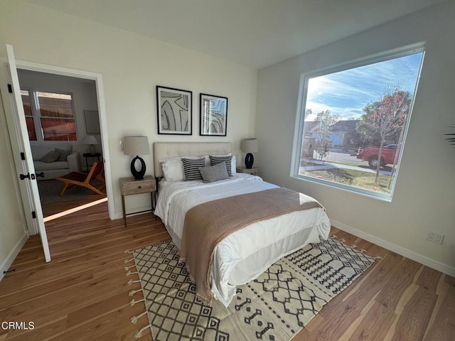 1160 W First St, Oxnard, CA 93030 - bedroom with multiple windows, wood finished floors, and baseboards