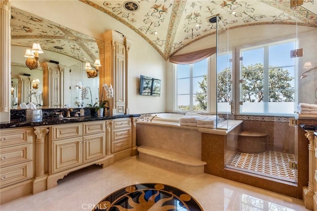 bathroom featuring vaulted ceiling, a shower with shower door, a garden tub, and vanity