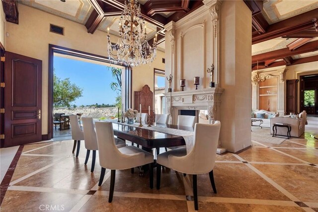 dining space featuring a chandelier, coffered ceiling, a towering ceiling, and baseboards