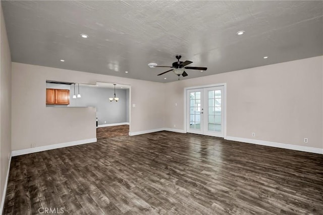 unfurnished living room with a ceiling fan, french doors, dark wood finished floors, and baseboards