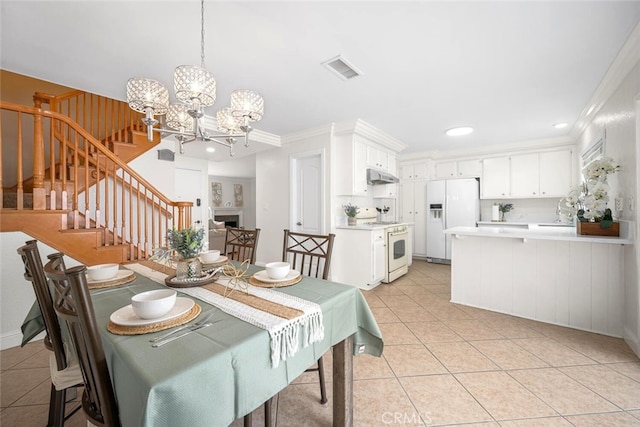 dining area with light tile patterned flooring, visible vents, stairs, and a chandelier